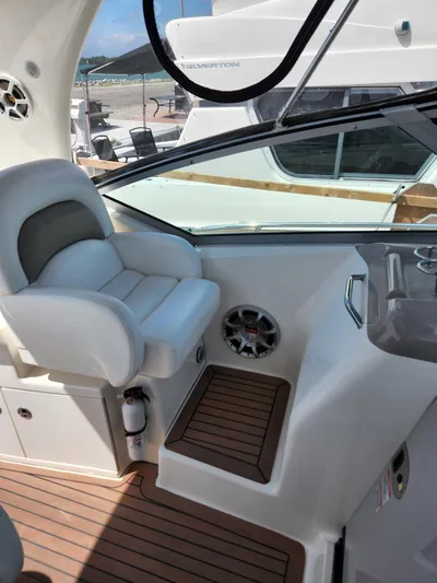  Yacht Photos Pics 2005 Sea Ray 340 Sundancer cockpit with white seating and wood flooring.