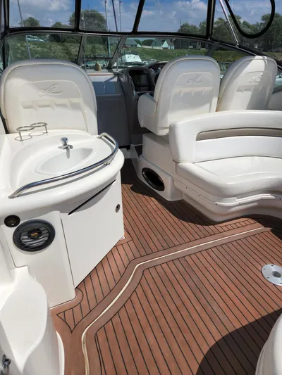  Yacht Photos Pics 2005 Sea Ray 340 Sundancer interior with seating, sink, and wood flooring.