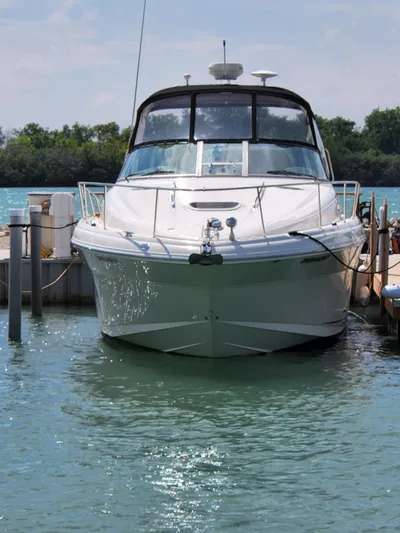  Yacht Photos Pics 2005 Sea Ray 340 Sundancer docked in clear blue water.