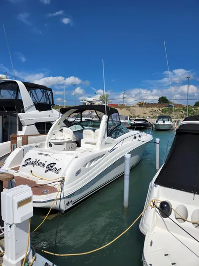 Yacht Photos Pics 2005 Sea Ray 340 Sundancer docked in a marina under a clear blue sky.