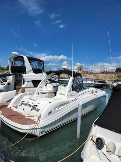  Yacht Photos Pics 2005 Sea Ray 340 Sundancer docked at marina under clear blue sky.