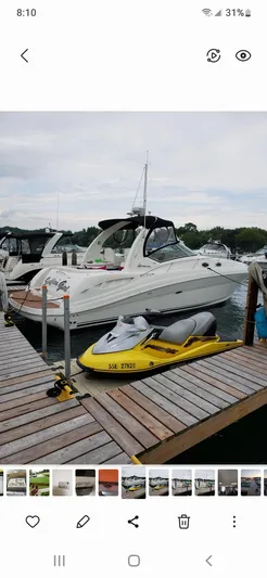  Yacht Photos Pics 2005 Sea Ray 340 Sundancer docked with yellow jet ski in foreground.