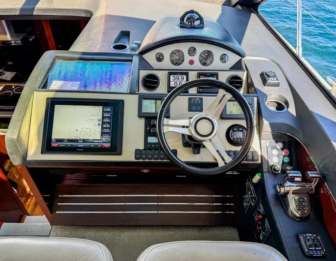 Bottoms Up Yacht Photos Pics 2015 Princess V52 yacht helm with navigation screens and steering wheel.