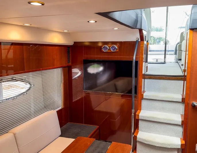 Bottoms Up Yacht Photos Pics Luxurious interior of 2015 Princess V52 yacht with modern wood finishes and elegant seating.