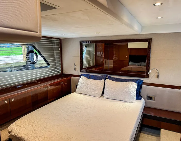 Bottoms Up Yacht Photos Pics Luxurious 2015 Princess V52 yacht bedroom with elegant wood finishes and large window.