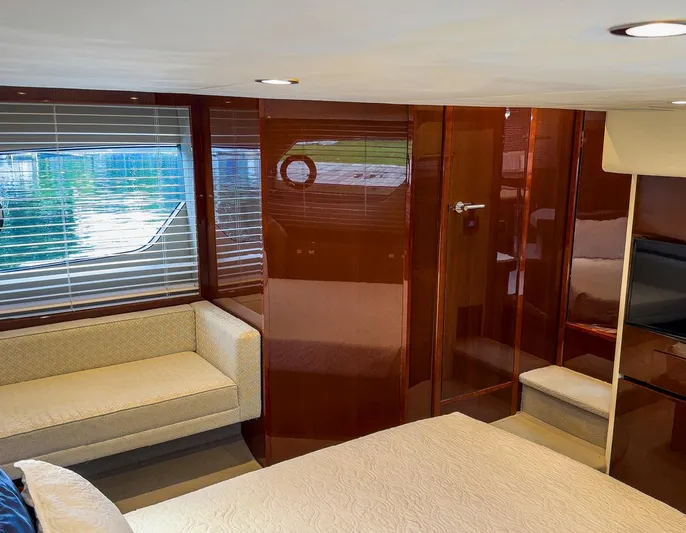 Bottoms Up Yacht Photos Pics Luxurious interior of 2015 Princess V52 yacht with elegant wood paneling and cozy seating.