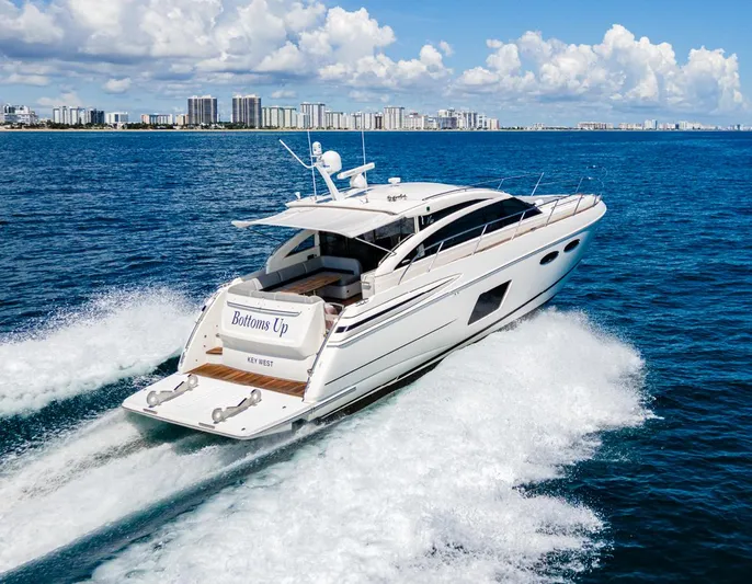 Bottoms Up Yacht Photos Pics 2015 Princess V52 yacht cruising on open water with city skyline in background.