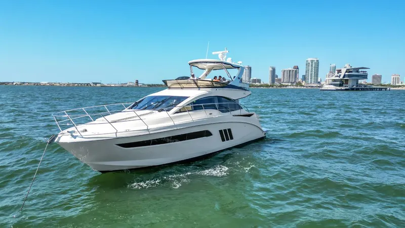  Yacht Photos Pics 2015 Sea Ray 510 Fly yacht cruising on open water with city skyline in background.