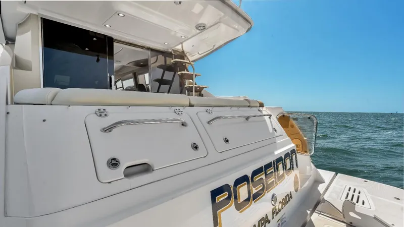  Yacht Photos Pics 2015 Sea Ray 510 Fly yacht on open water, rear view, sunny day.