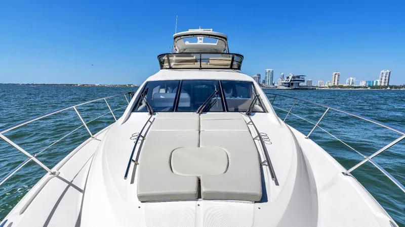  Yacht Photos Pics 2015 Sea Ray 510 Fly yacht cruising on open water with city skyline in background.