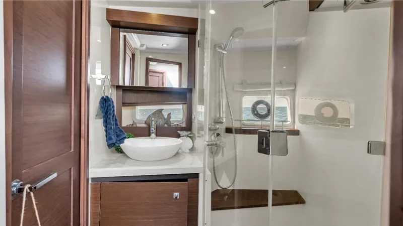  Yacht Photos Pics Luxurious bathroom in 2015 Sea Ray 510 Fly yacht with modern fixtures and wooden accents.