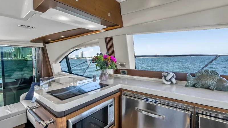  Yacht Photos Pics Luxurious interior of 2015 Sea Ray 510 Fly yacht with modern kitchen and ocean view.