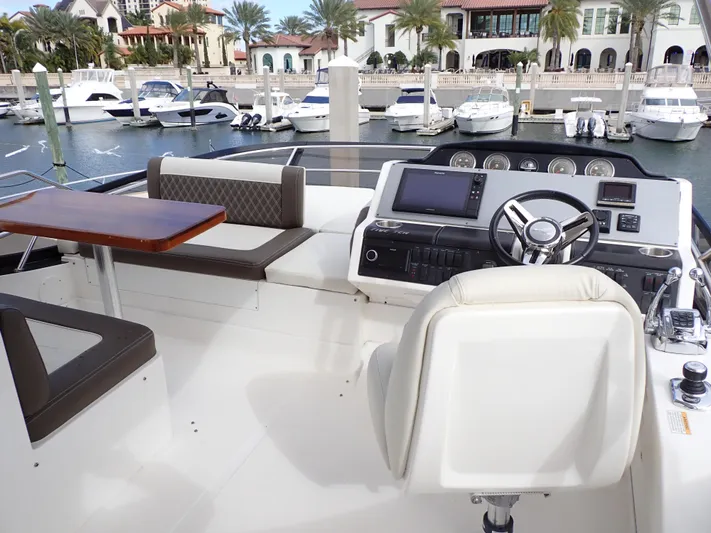  Yacht Photos Pics Flybridge of 2015 Sea Ray 510 Fly yacht with helm, seating, and marina view.