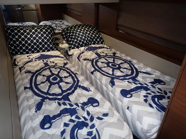  Yacht Photos Pics Twin beds with nautical-themed bedding in a 2015 Sea Ray 510 Fly cabin.