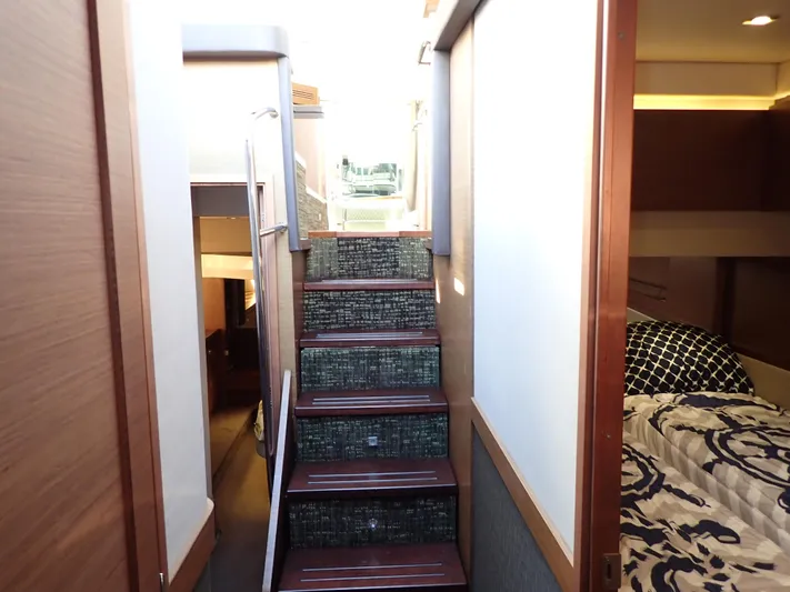  Yacht Photos Pics Interior view of 2015 Sea Ray 510 Fly yacht, featuring stairs and cozy cabin.