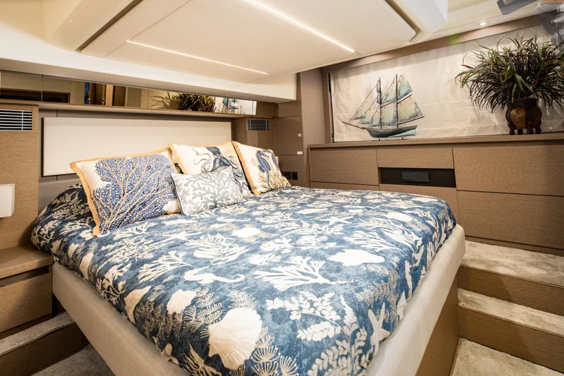Margie Yacht Photos Pics Luxurious bedroom interior on a 2018 Prestige 460 yacht, featuring nautical-themed decor.