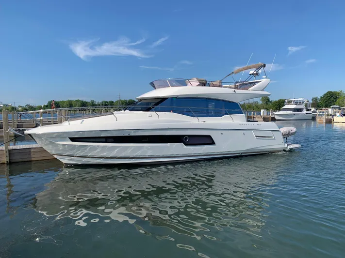 Margie Yacht Photos Pics 2018 Prestige 460 yacht docked in a marina under clear blue skies.