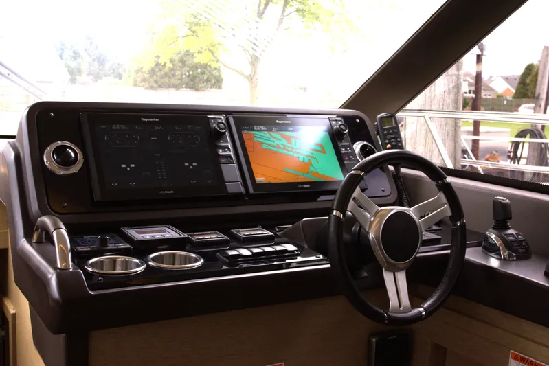Margie Yacht Photos Pics Cockpit of 2018 Prestige 460 yacht with advanced navigation systems and steering wheel.