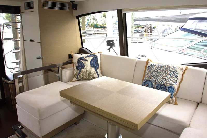 Margie Yacht Photos Pics Luxurious interior of 2018 Prestige 460 yacht with elegant seating and decorative pillows.