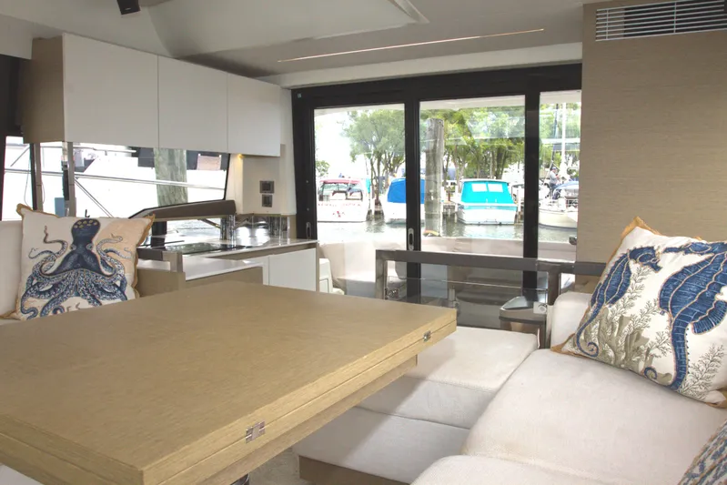 Margie Yacht Photos Pics Luxurious interior of 2018 Prestige 460 yacht with nautical-themed cushions and modern furnishings.