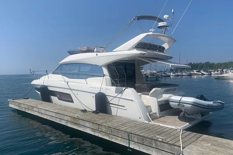 Margie Yacht Photos Pics 2018 Prestige 460 yacht docked at a marina on a sunny day.