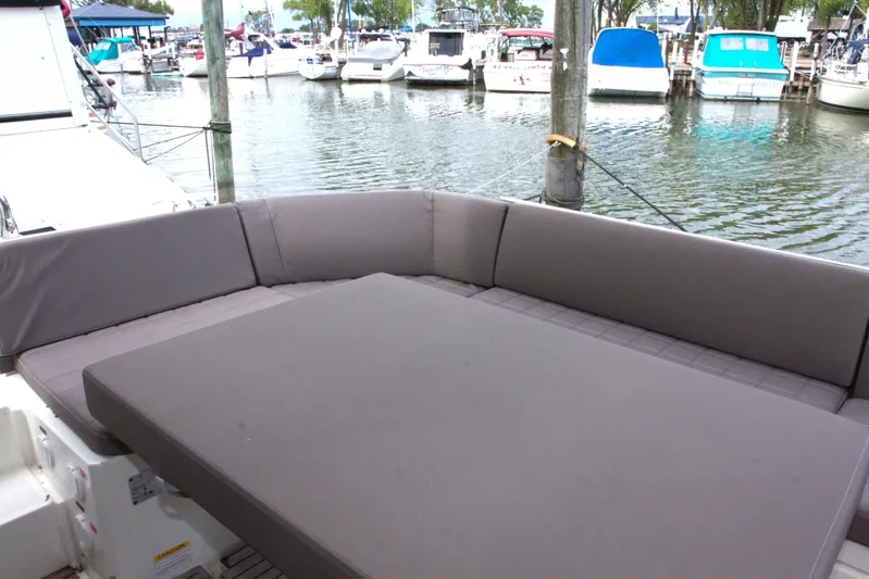 Margie Yacht Photos Pics Luxurious seating area on 2018 Prestige 460 yacht, docked at a marina.