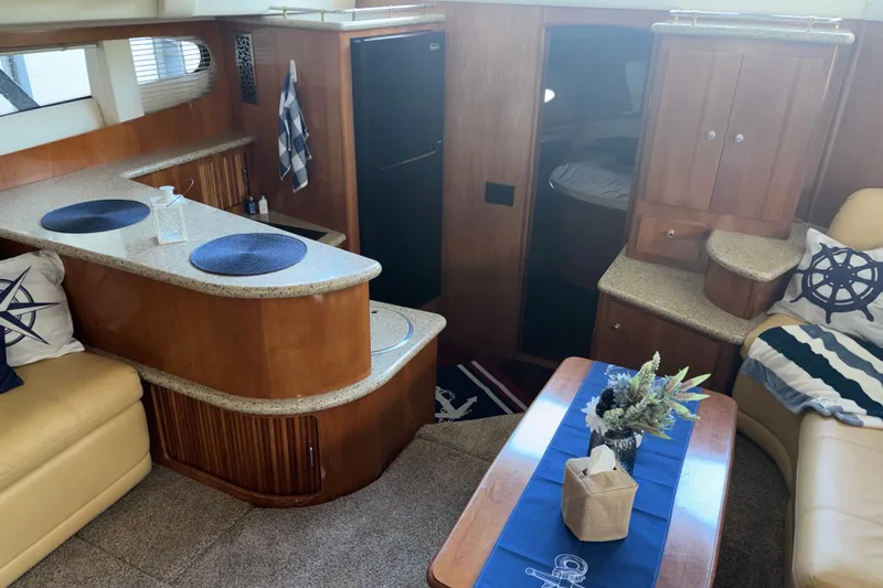  Yacht Photos Pics Luxurious interior of 2001 Carver 396 Motor Yacht with elegant wood finishes and nautical decor.