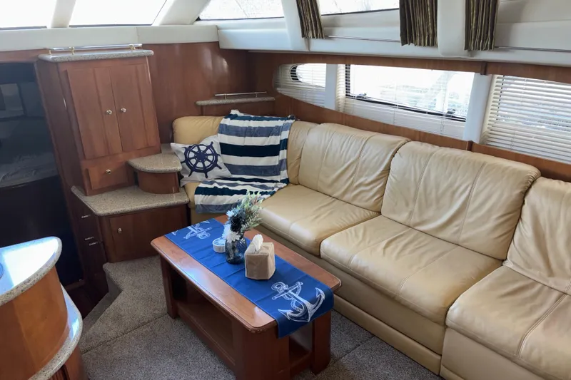  Yacht Photos Pics Interior of 2001 Carver 396 Motor Yacht with beige leather seating and nautical decor.