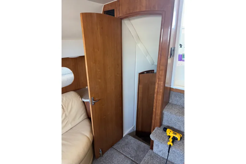  Yacht Photos Pics Interior of 2001 Carver 396 Motor Yacht with open wooden door and carpeted stairs.