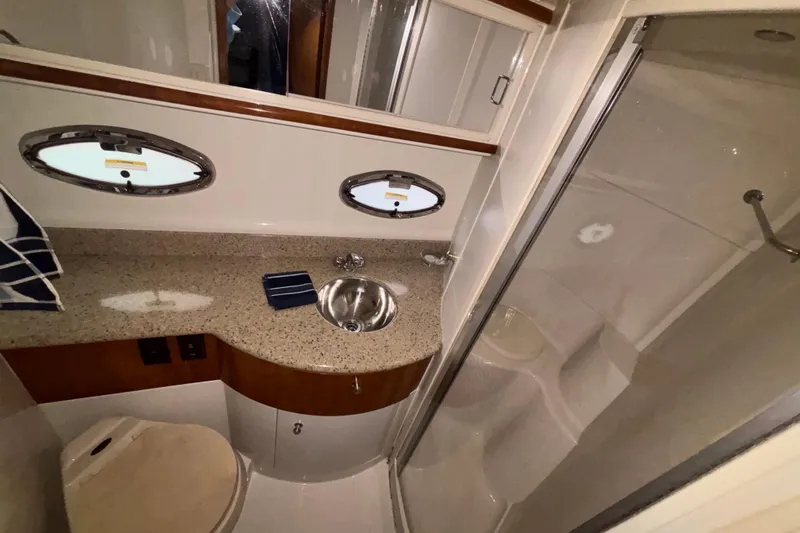  Yacht Photos Pics 2001 Carver 396 Motor Yacht bathroom with sink, shower, and porthole windows.
