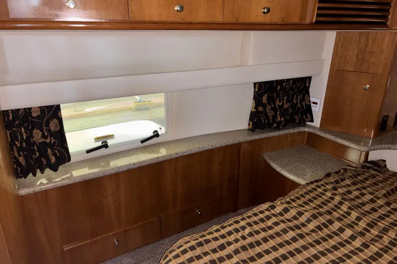  Yacht Photos Pics Interior of 2001 Carver 396 Motor Yacht with wood cabinetry and window view.