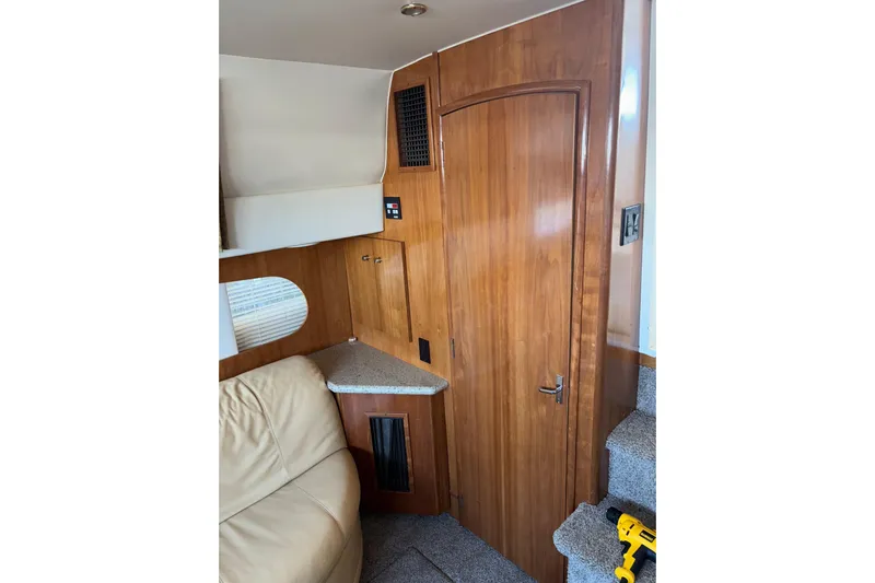  Yacht Photos Pics Interior of 2001 Carver 396 Motor Yacht with wooden door and beige seating.