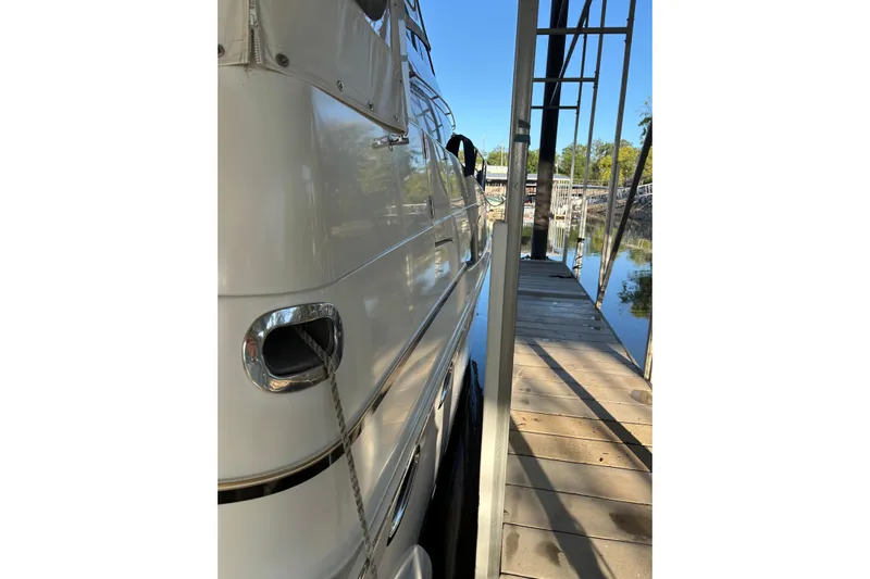  Yacht Photos Pics Side view of a 2001 Carver 396 Motor Yacht docked by a wooden pier.