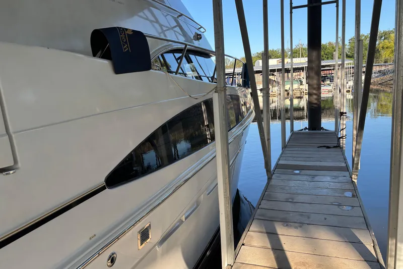  Yacht Photos Pics 2001 Carver 396 Motor Yacht docked at marina with clear water reflection.