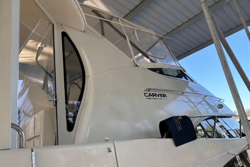  Yacht Photos Pics 2001 Carver 396 Motor Yacht docked under a metal canopy.