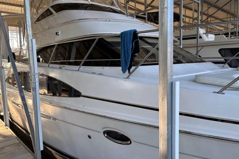  Yacht Photos Pics 2001 Carver 396 Motor Yacht docked in a marina with a blue towel hanging.