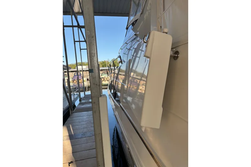  Yacht Photos Pics 2001 Carver 396 Motor Yacht docked, side view with reflections on water.