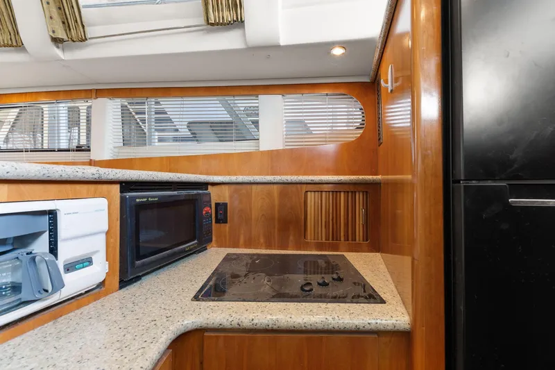  Yacht Photos Pics Interior of 2001 Carver 396 Motor Yacht kitchen with appliances and wooden cabinetry.
