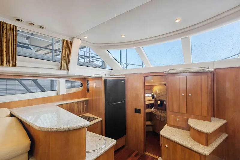  Yacht Photos Pics Interior of 2001 Carver 396 Motor Yacht with modern kitchen and wood cabinetry.