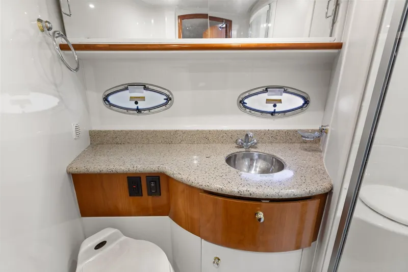  Yacht Photos Pics Luxurious bathroom in 2001 Carver 396 Motor Yacht with granite countertop and porthole windows.