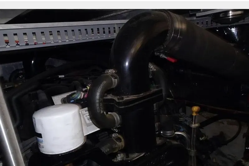  Yacht Photos Pics Engine components of a 2001 Carver 396 Motor Yacht, featuring hoses and a filter.