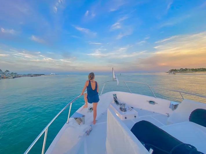 Daddo O Yacht Photos Pics Woman enjoying sunset on 2023 Outer Reef Yachts 720 Azure Motoryacht deck.