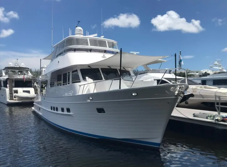 Daddo O Yacht Photos Pics 2023 Outer Reef Yachts 720 Azure Custom Cockpit Motoryacht docked under blue sky.
