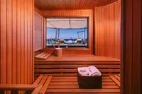 Luxurious wooden sauna interior on 2008 Benetti Custom yacht with ocean view.
