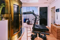 Luxurious yacht gym with treadmill, weights, and sauna on a 2008 Benetti Custom model.