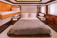 Luxurious bedroom interior on a 2008 Benetti Custom yacht, featuring elegant wood finishes and modern design.