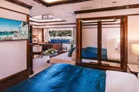 Luxurious 2008 Benetti Custom yacht bedroom with elegant decor and scenic window view.