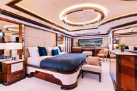 Luxurious bedroom interior on a 2008 Benetti Custom yacht, featuring elegant furnishings and ambient lighting.