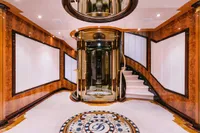 Luxurious interior of 2008 Benetti Custom yacht with elegant wood paneling and spiral staircase.