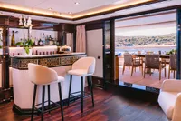 Luxurious interior of 2008 Benetti Custom yacht with elegant bar and scenic outdoor dining area.